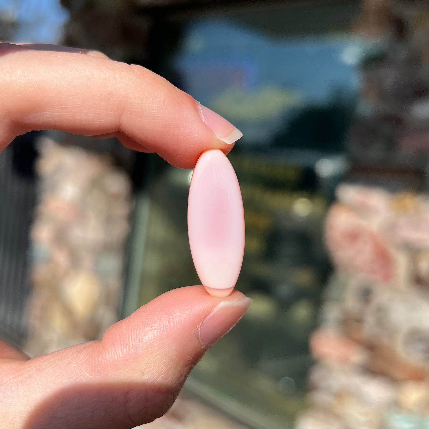 A loose, marquise cabochon cut pink common opal from Peru. The opal has no play of color.
