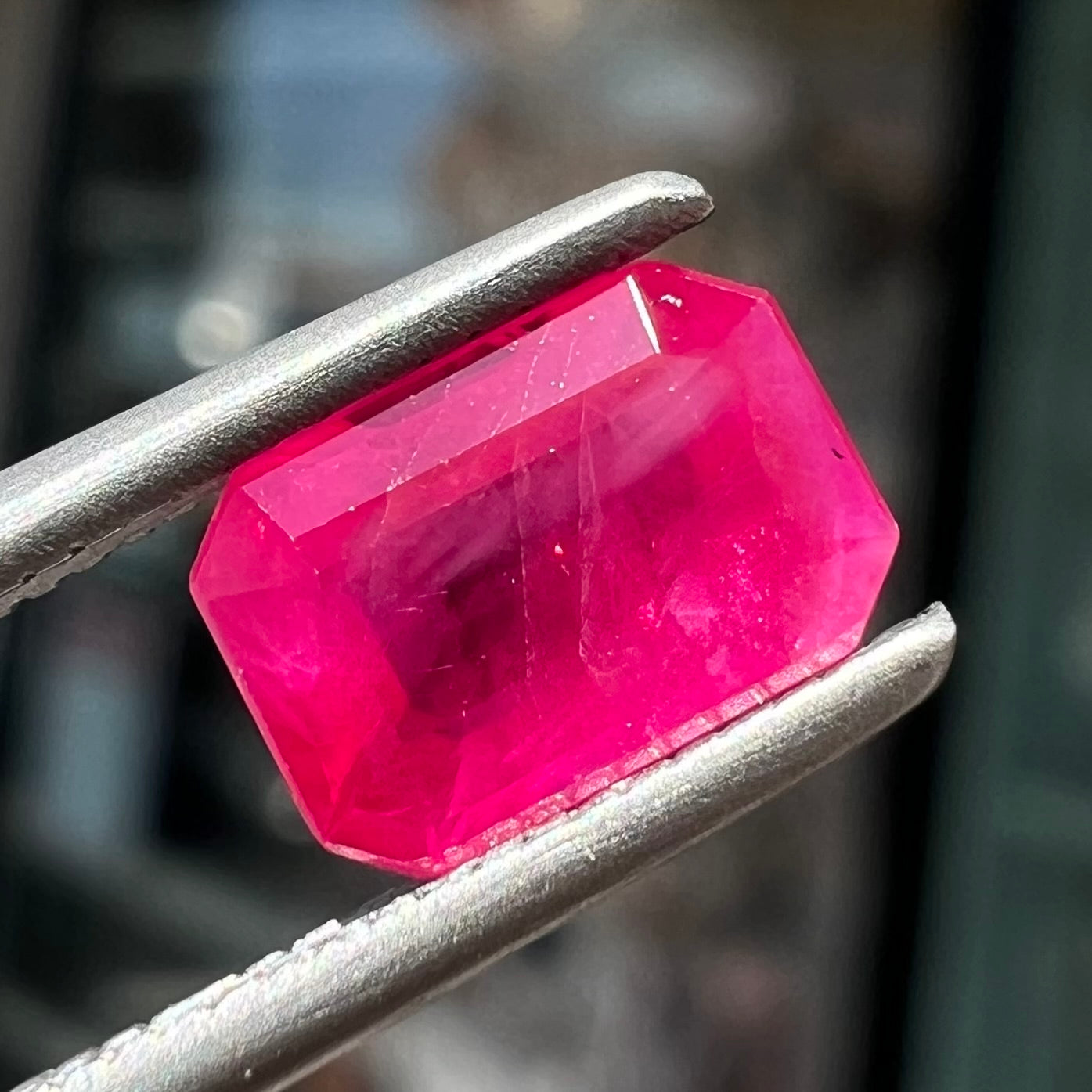 A natural, emerald cut Burma ruby gemstone.  The stone is pinkish red color.