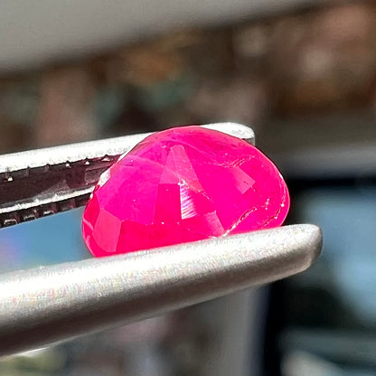 A faceted round brilliant cut Burma ruby gemstone.  The stone is certified as natural by Guild Laboratories.