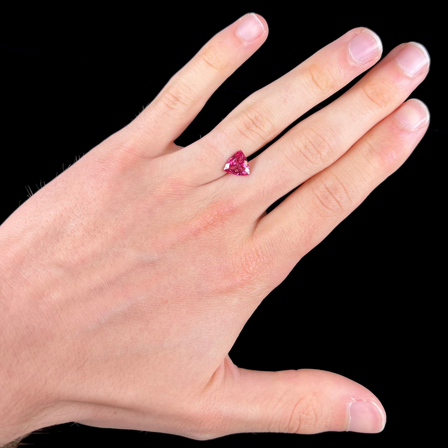 A trillion cut pink tourmaline gemstone.