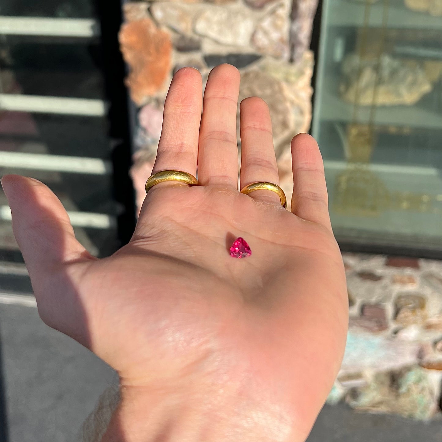 A loose, trillion cut rubellite tourmaline gemstone.