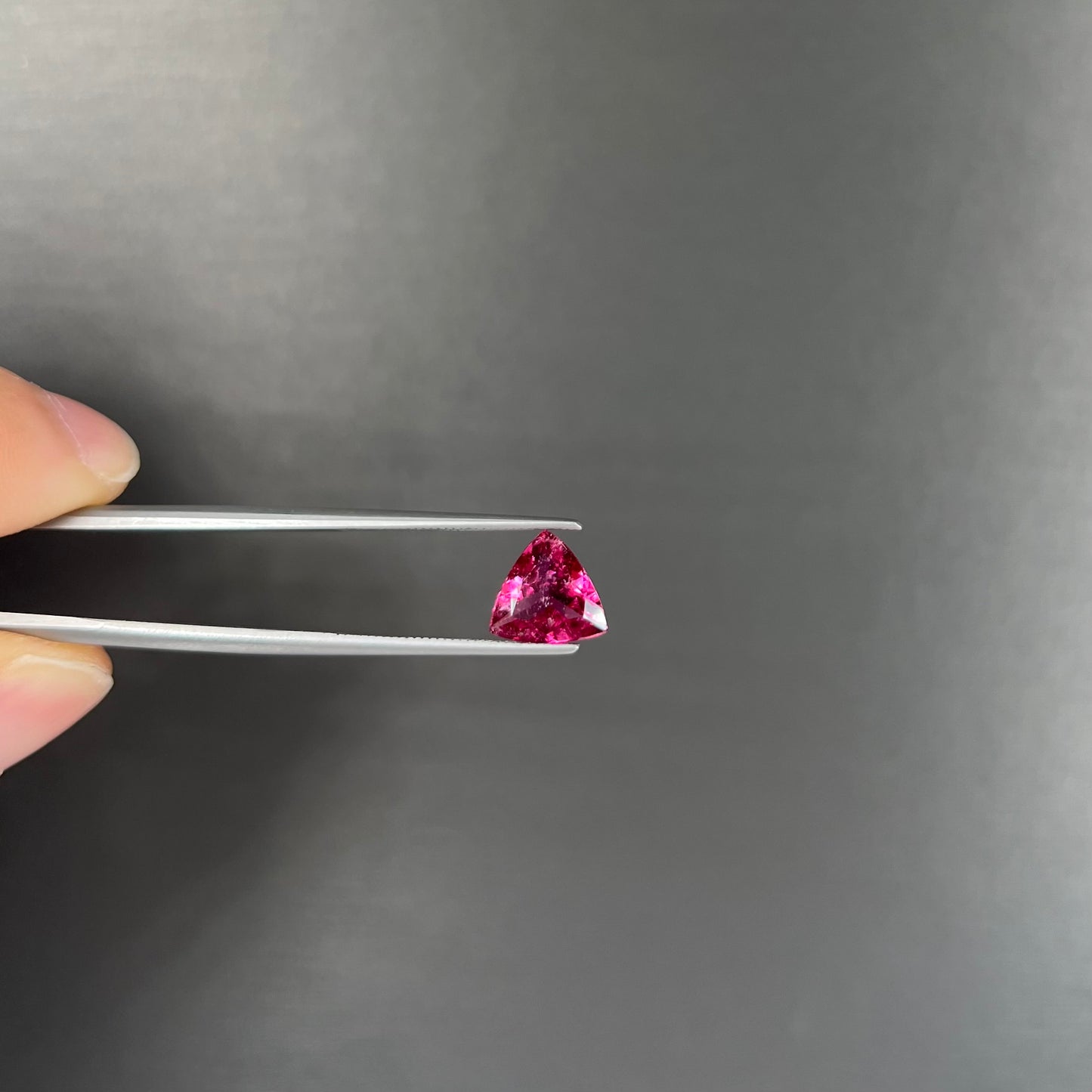 A trillion cut pink tourmaline gemstone.