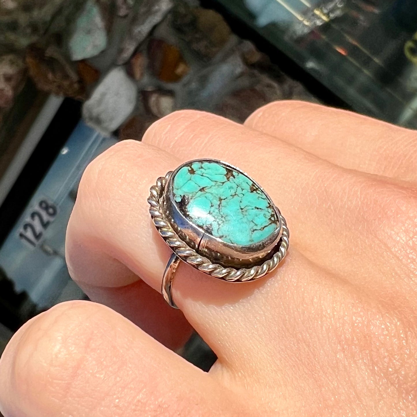 A handmade ladies' turquoise solitaire ring. The ring has a rope bezel design.