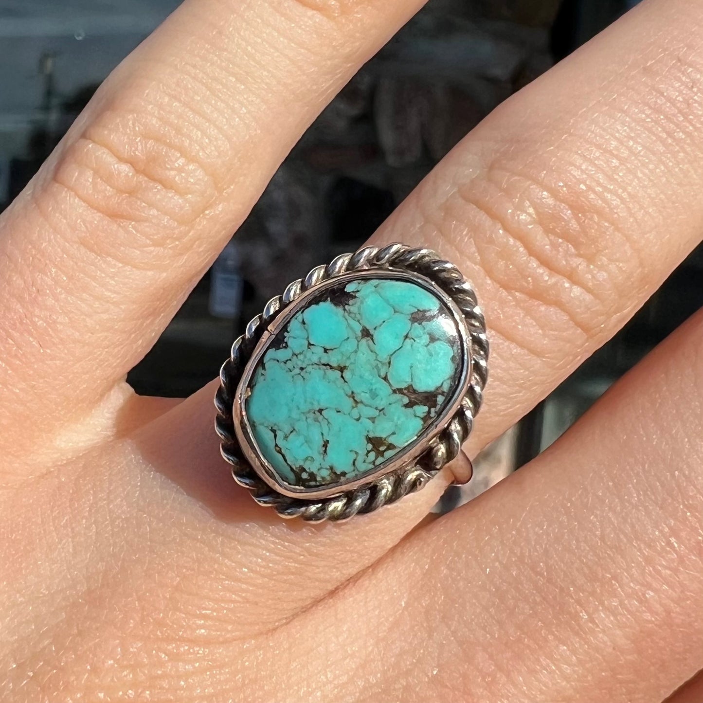 A handmade ladies' turquoise solitaire ring. The ring has a rope bezel design.
