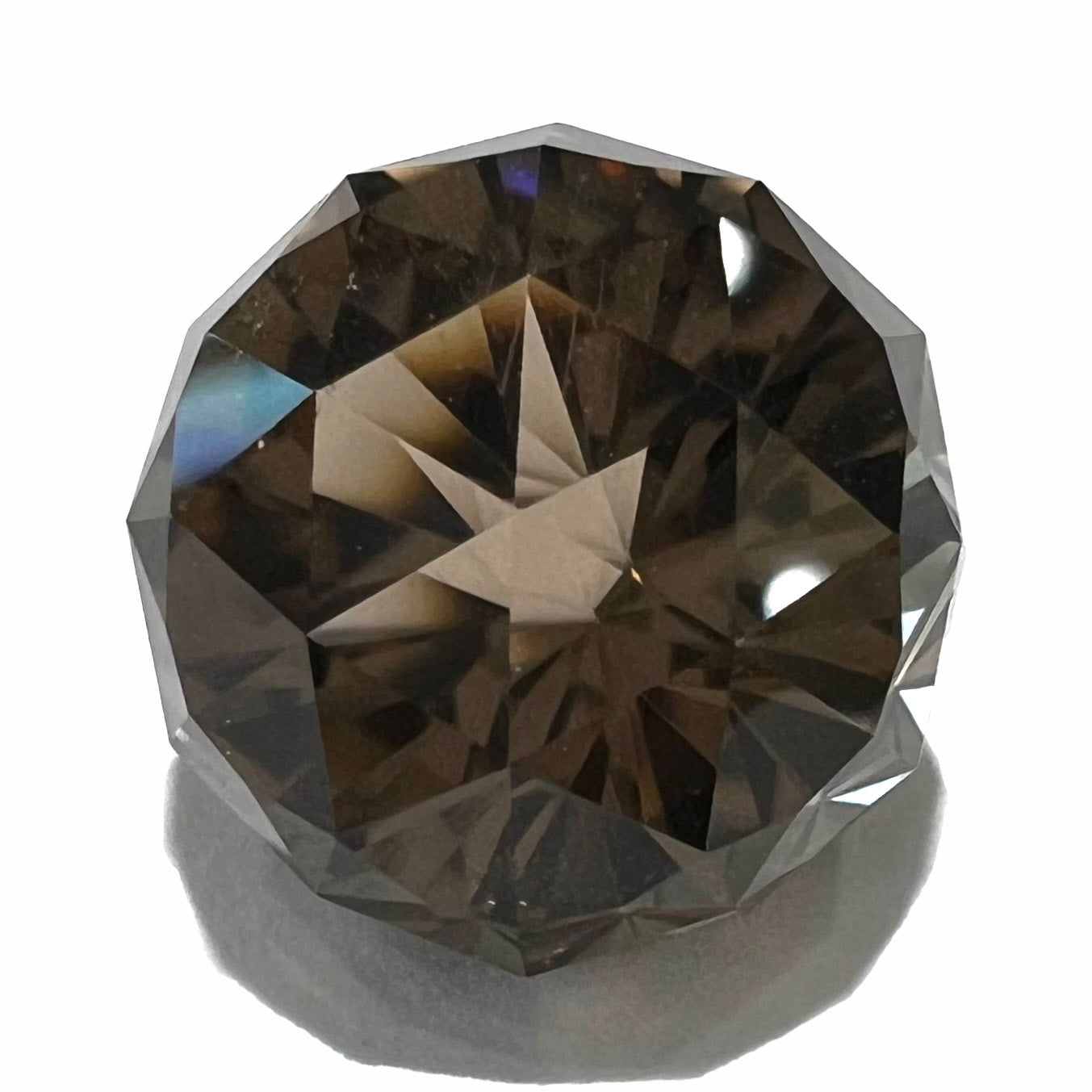 A loose, modified brilliant Portuguese cut smoky quartz gemstone.
