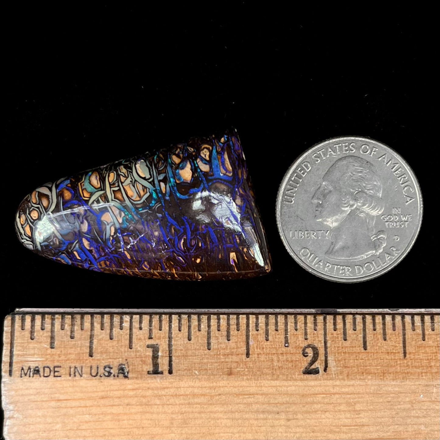 A loose boulder opal stone from Koroit, Australia. The opal has a blue and purple pattern.