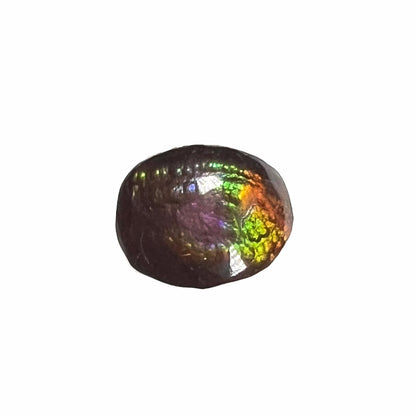A loose, oval cabochon cut fire agate stone from Mexico.  The stone has an iridescent purple and teal blue eye of color.