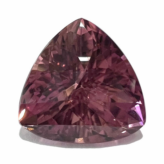 A loose, checkerboard trillion cut purple tourmaline gemstone.