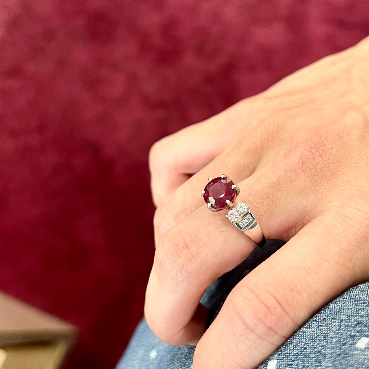 A ladies' sterling silver natural ruby and white zircon ring. The real ruby is glass filled.
