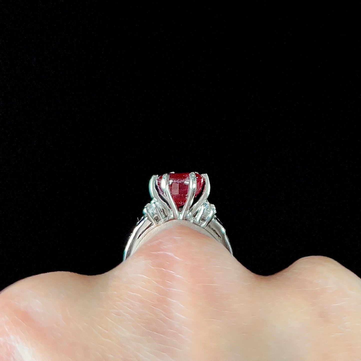 A ladies' sterling silver natural ruby and white zircon ring. The real ruby is glass filled.