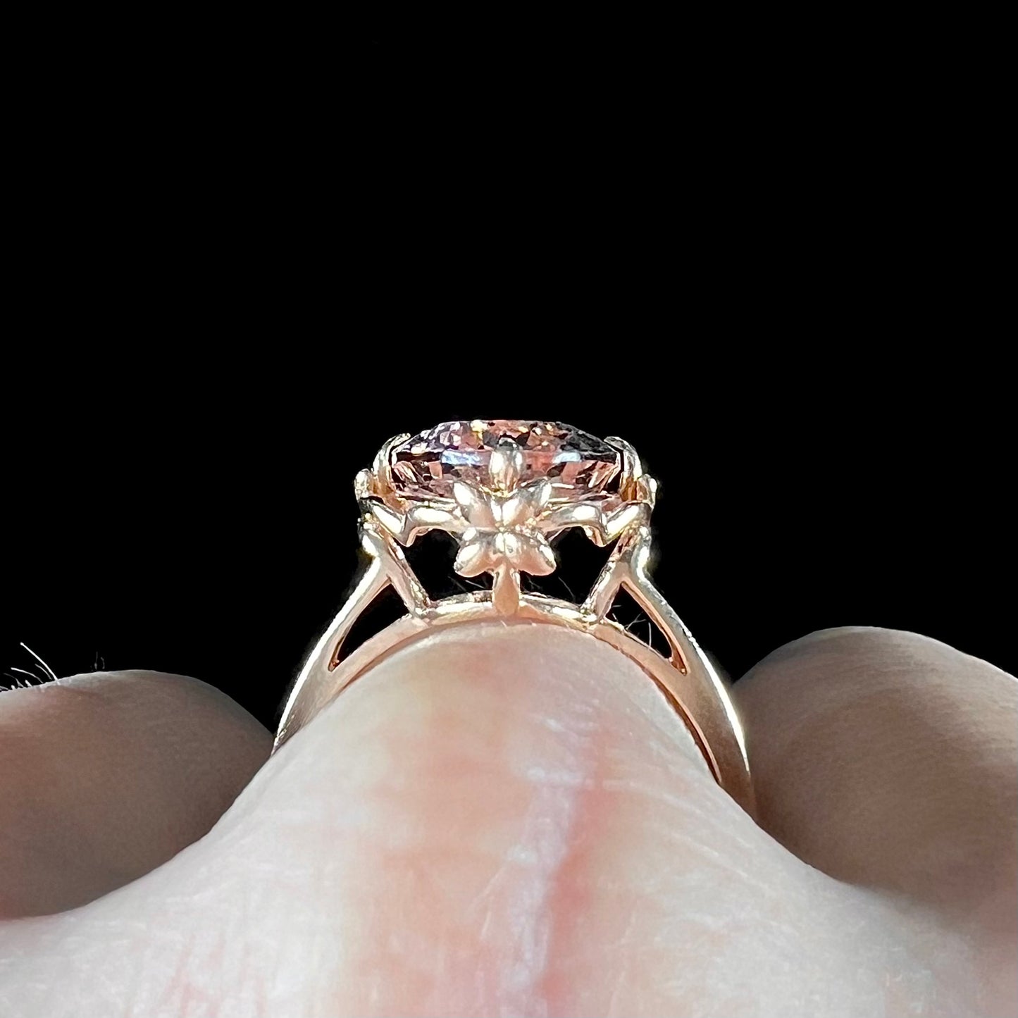 A ladies' rose gold solitaire ring set with an oval cut pink morganite gemstone.