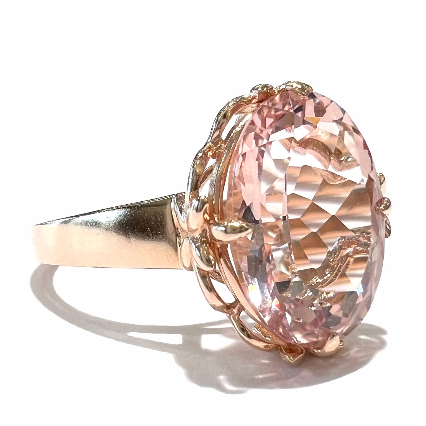 A ladies' rose gold solitaire ring set with an oval cut pink morganite gemstone.