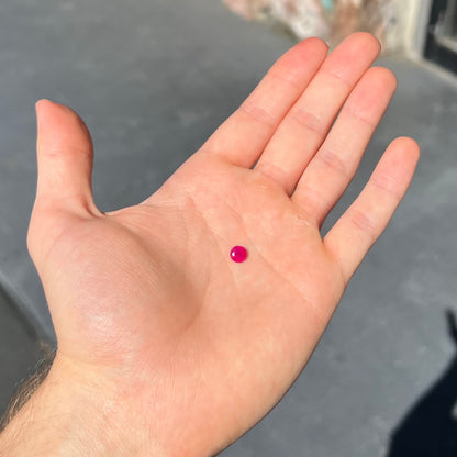 A faceted round brilliant cut Burma ruby gemstone.  The stone is certified as natural by Guild Laboratories.