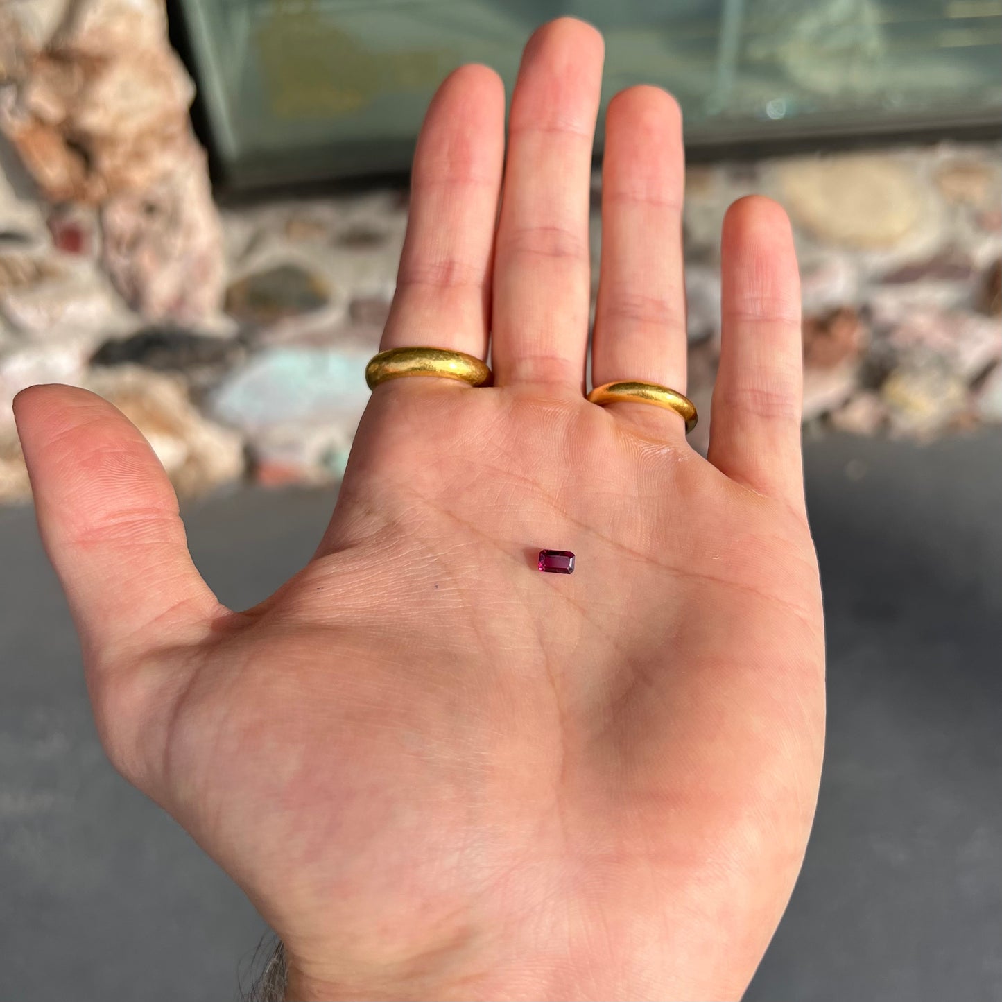 An emerald cut purplish red natural ruby stone.