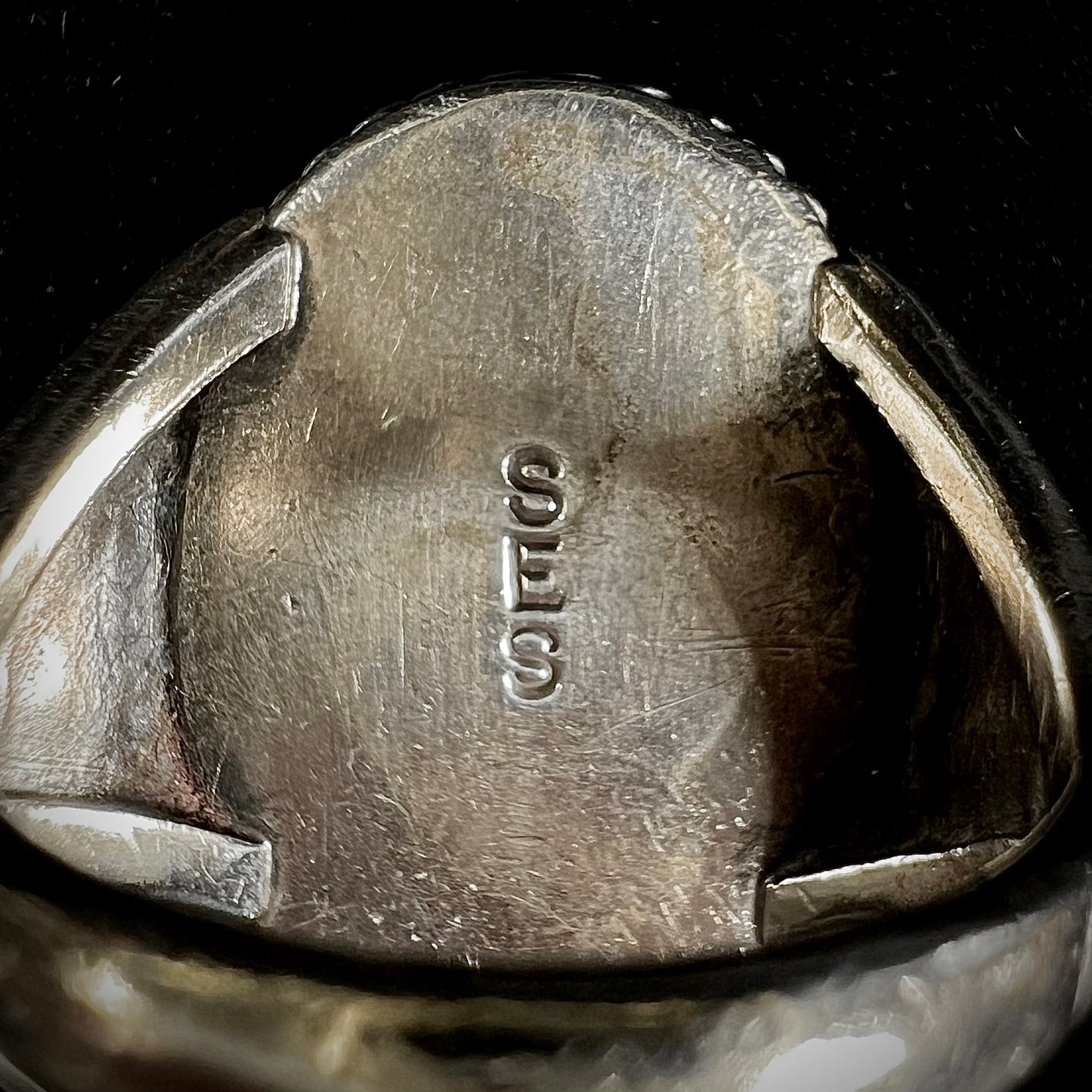 A men's sterling silver Morenci turquoise solitaire ring. The ring has a Southwest Navajo style stamp pattern.