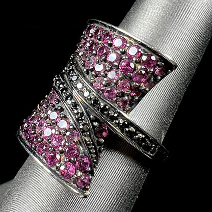 A ladies' bow-shaped designer ring pave set with purple rhodolite garnets and black spinel accents.