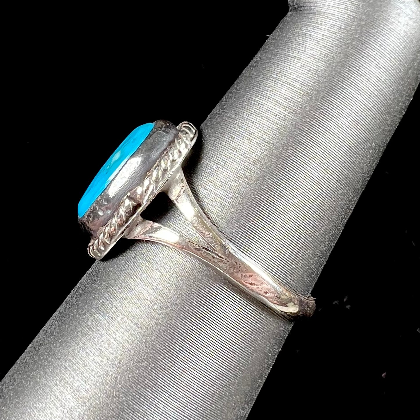 A vintage ladies' Pilot Mountain turquoise ring handmade in sterling silver with a rope accented bezel.