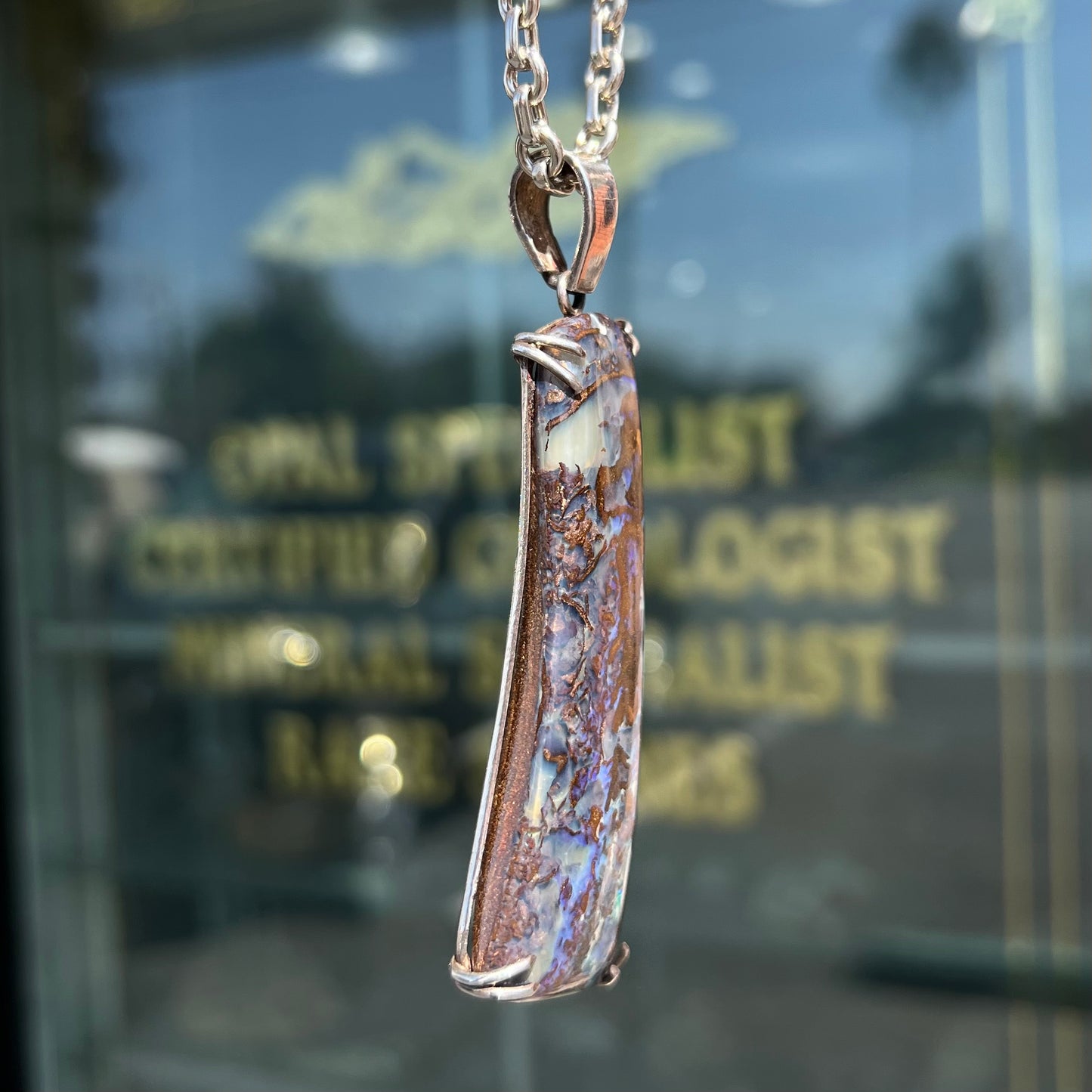 A men's sterling silver pendant set with a natural boulder opal from Quilpie, Australia.