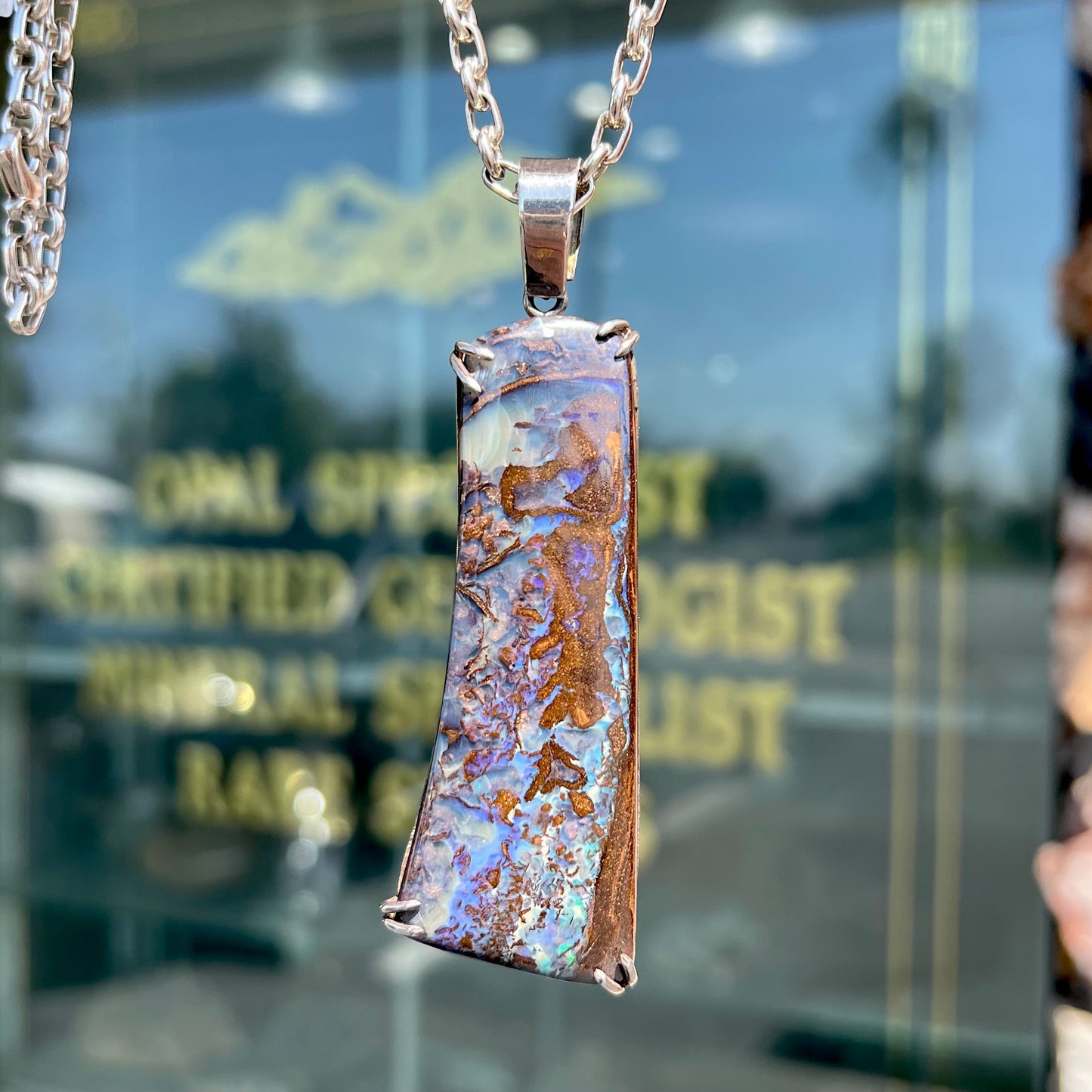 A men's sterling silver pendant set with a natural boulder opal from Quilpie, Australia.