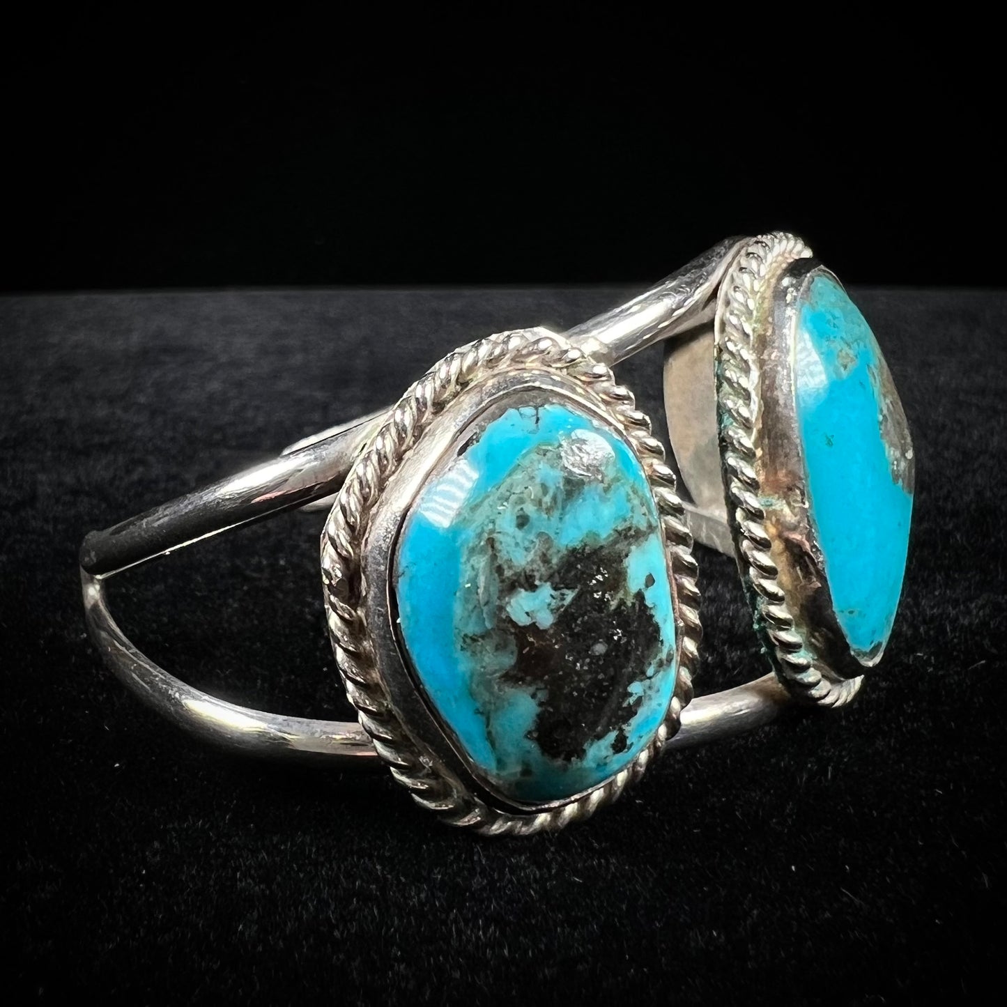 A ladies' three stone silver cuff bracelet accented with rope bezels and set with Morenci turquoise.