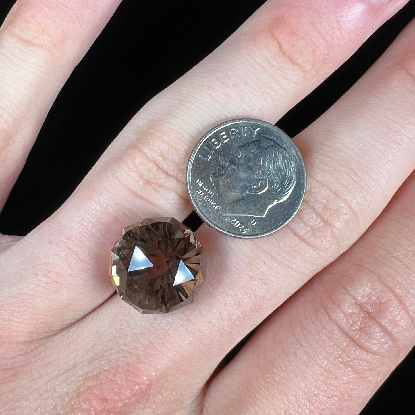 A loose, modified brilliant Portuguese cut smoky quartz gemstone.