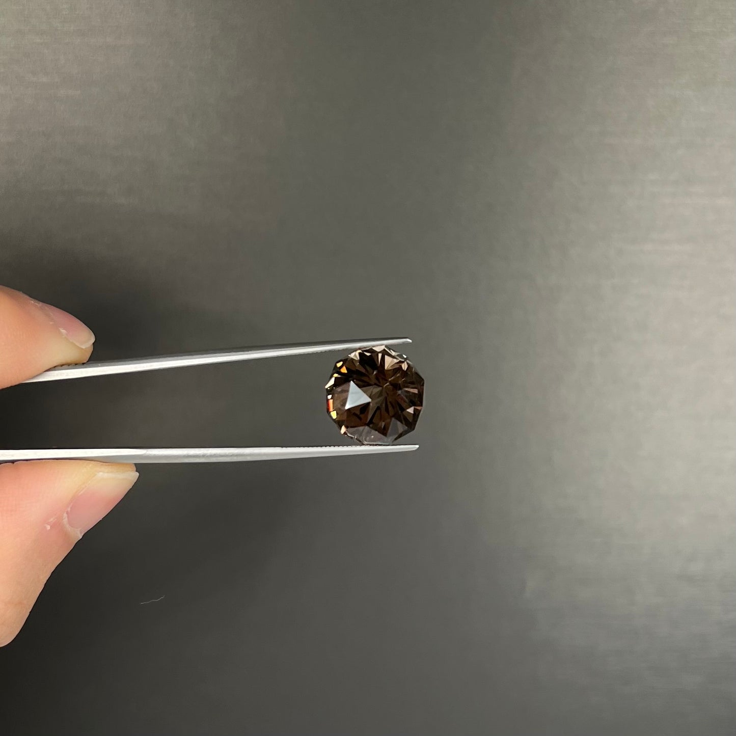 A loose, modified brilliant Portuguese cut smoky quartz gemstone.