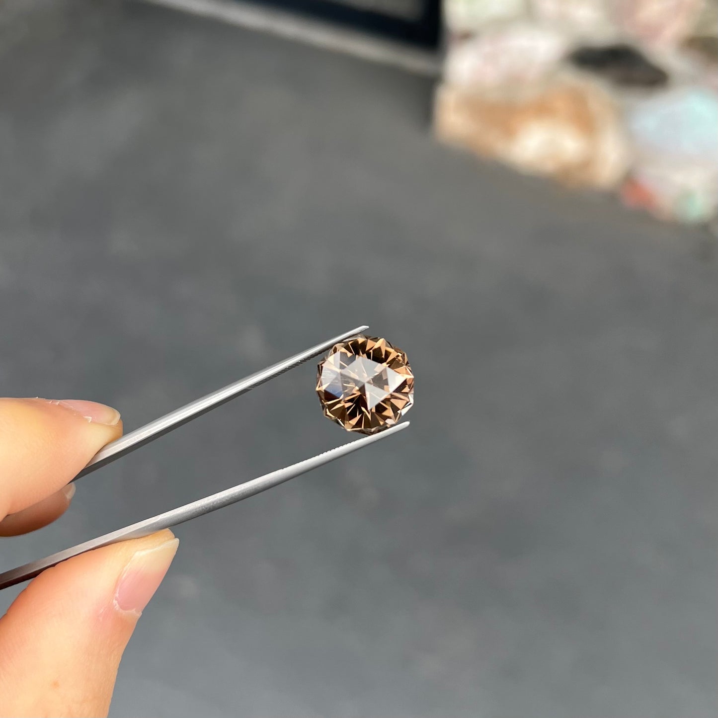 A loose, modified brilliant Portuguese cut smoky quartz gemstone.