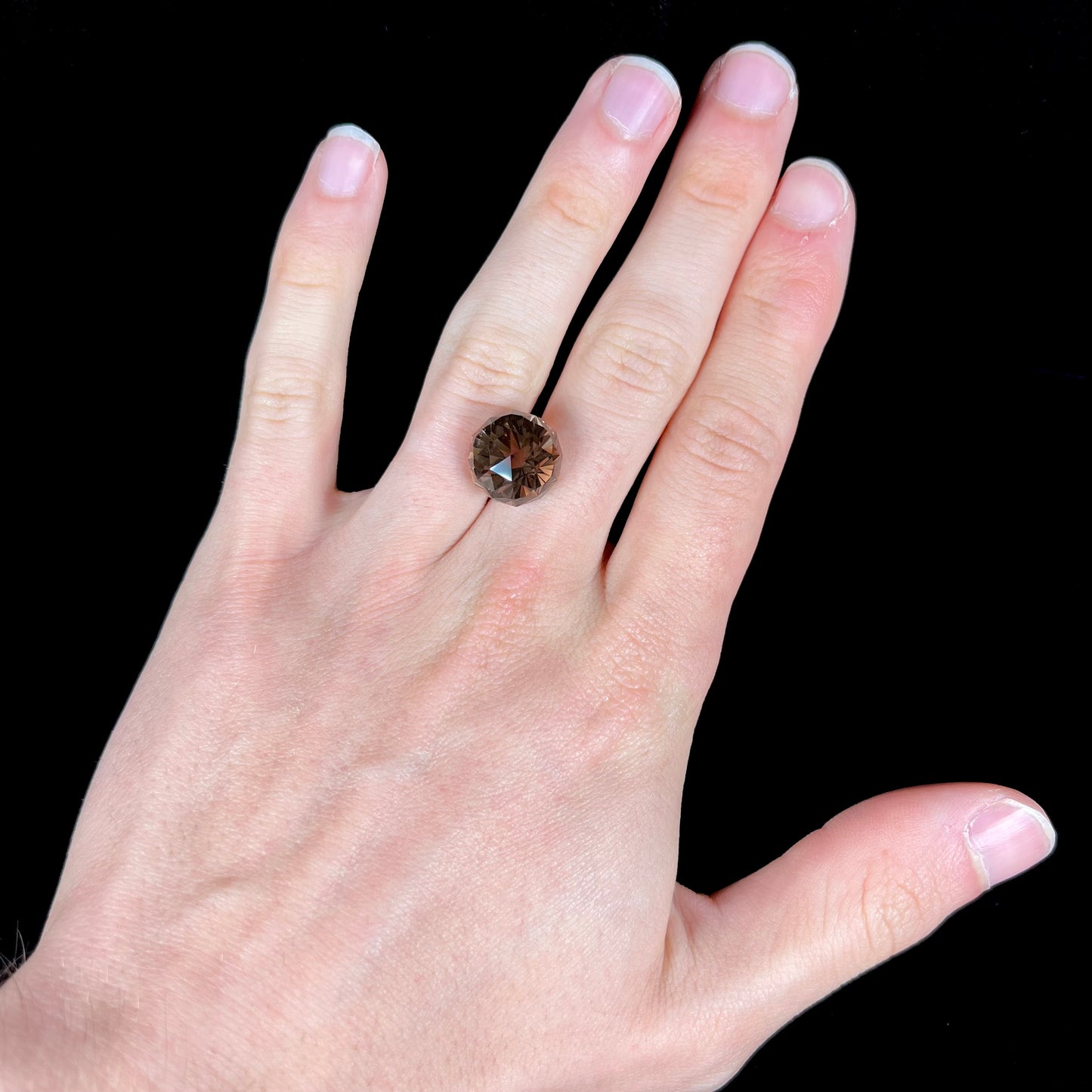 A loose, modified brilliant Portuguese cut smoky quartz gemstone.