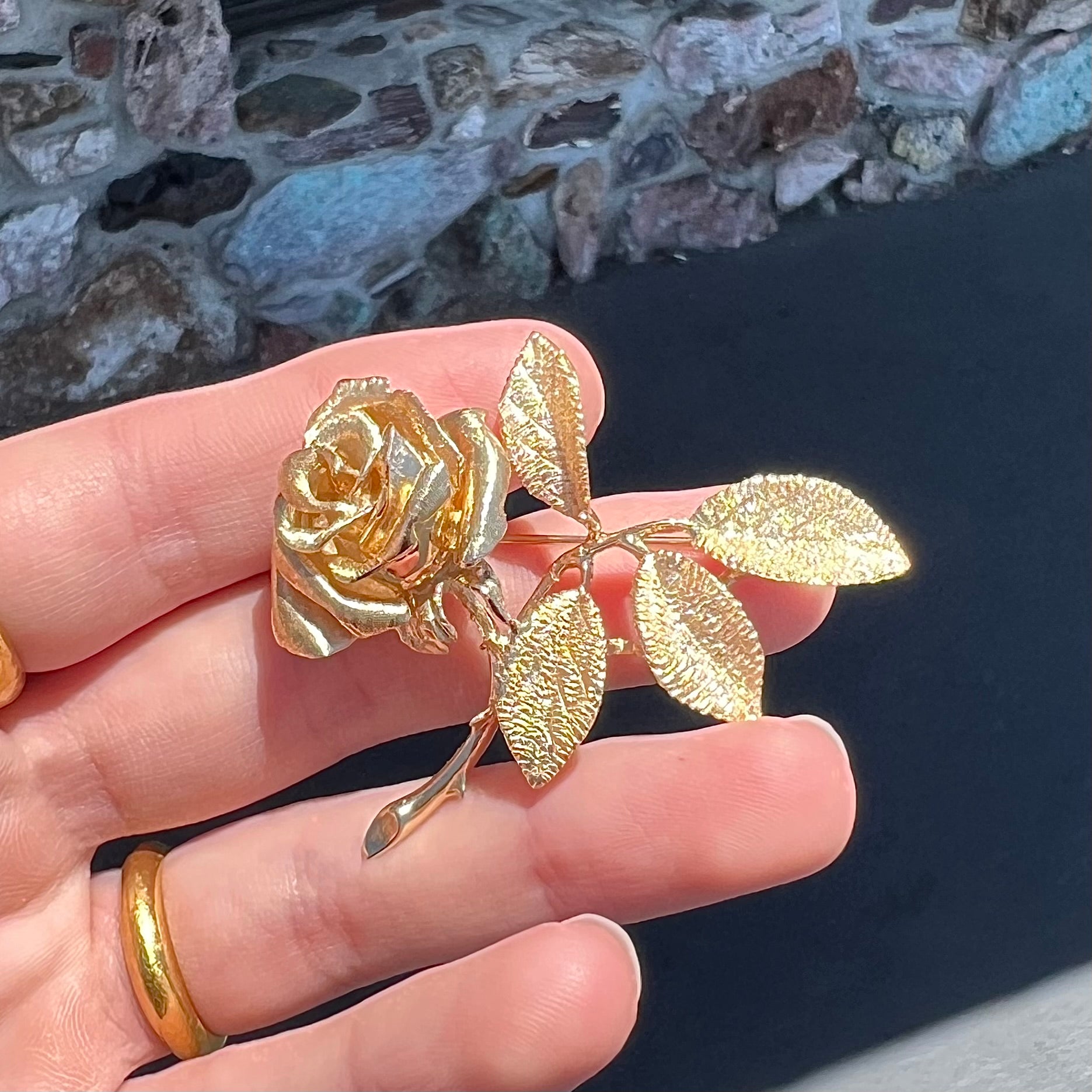 A vintage 14 karat yellow gold rose brooch.