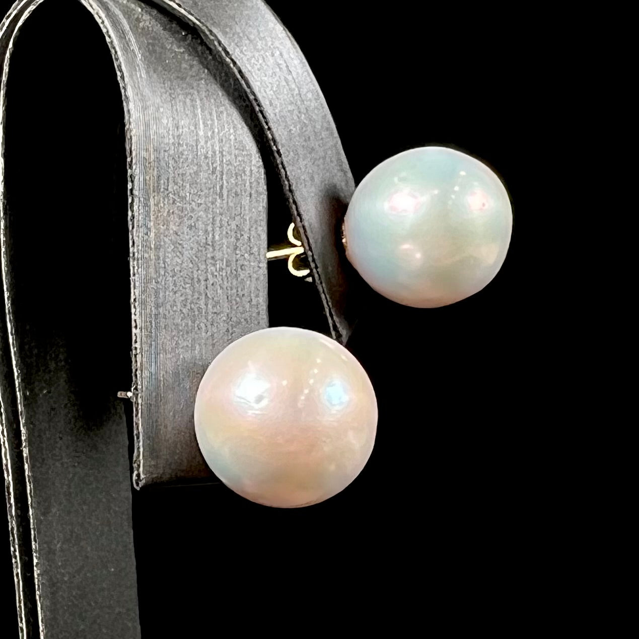 A pair of white South Seas pearl earrings with yellow gold push back friction posts.