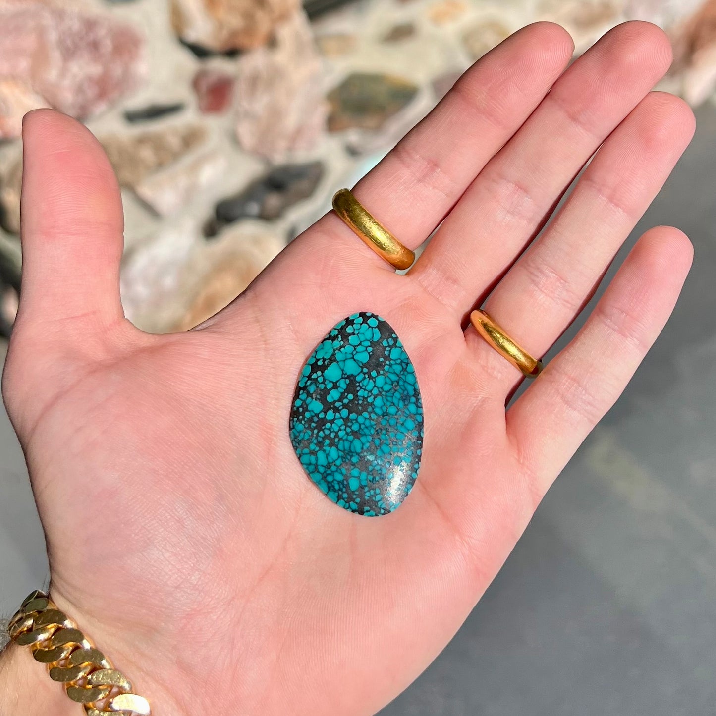 A polished, freeform shaped spiderweb turquoise cabochon from Lone Mountain Mine in Esmeralda County, Nevada.