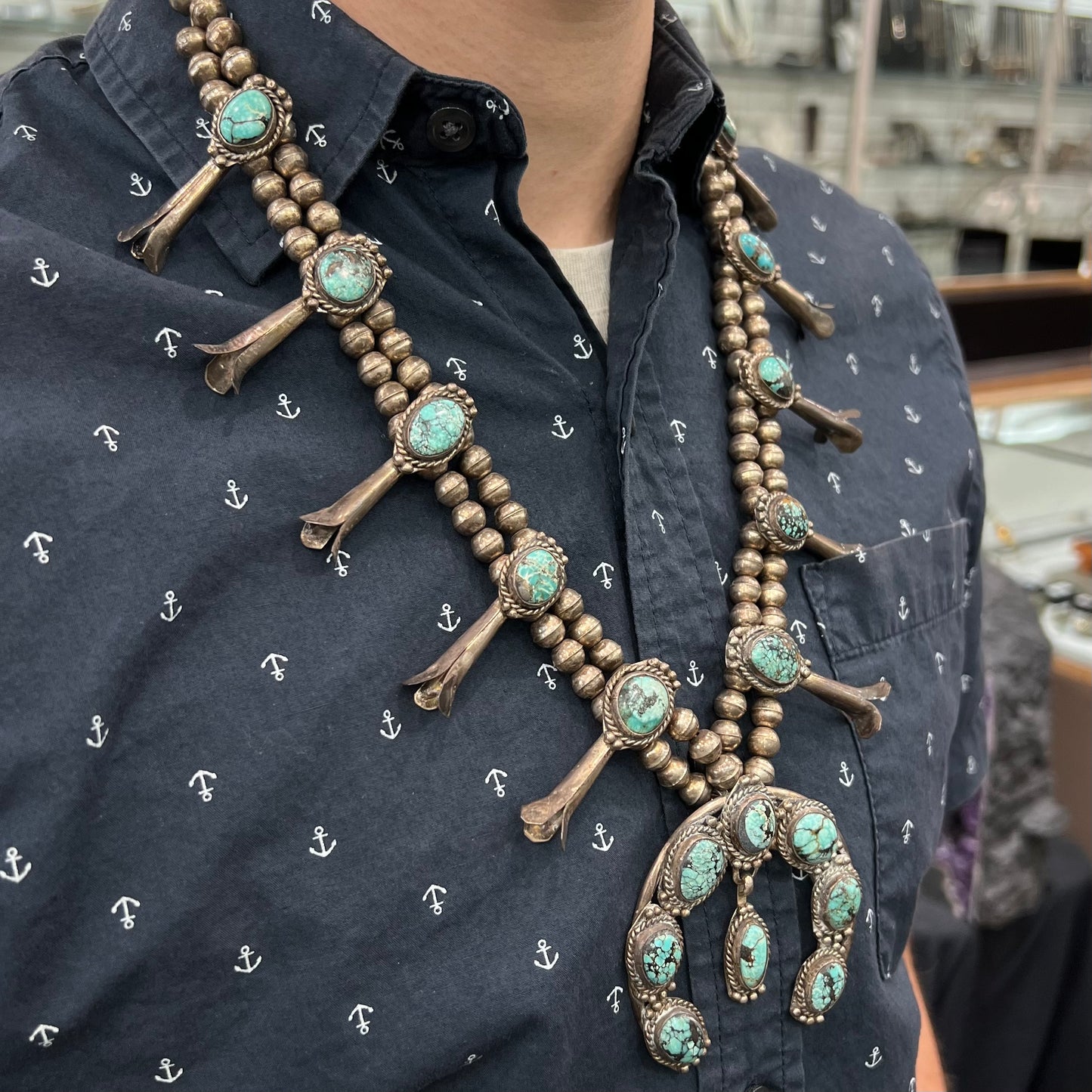 A Native American squash blossom necklace set with Number 8 MIne turquoise stones.