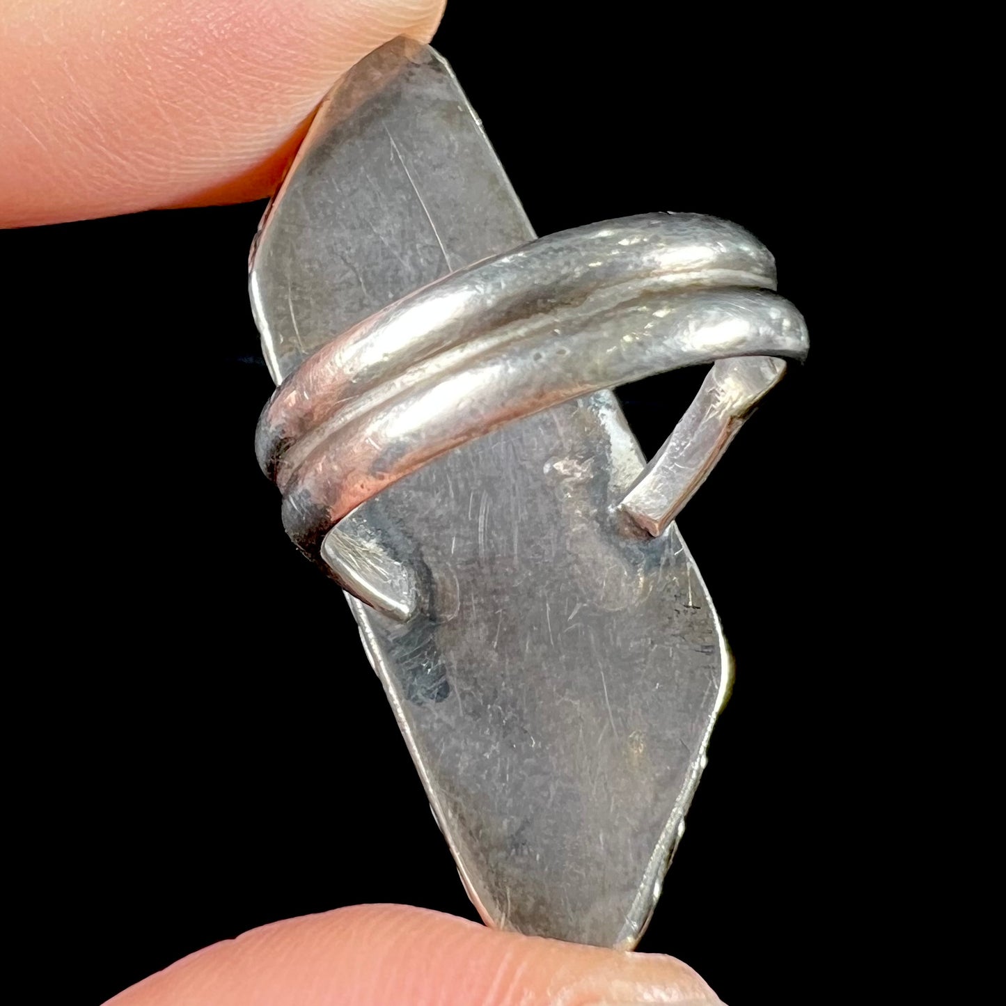 A vintage, Southwest style sterling silver ring set with a natural turquoise stone. The stone is blue with a black matrix.