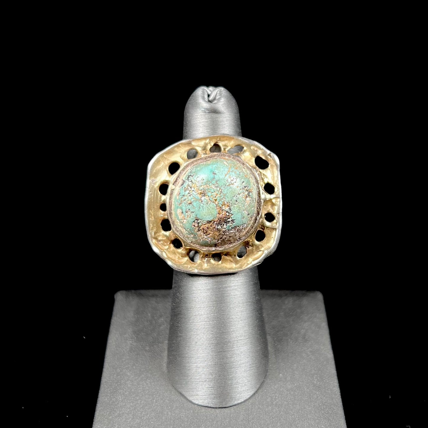 A unisex sterling silver ring with a gold wash, set with a natural, unstabilized Valley Blue turquoise stone.