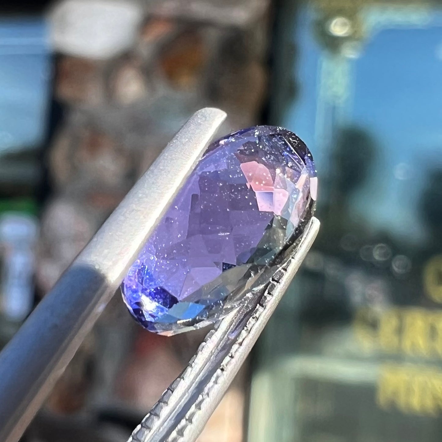 A loose, oval cut tanzanite gemstone.