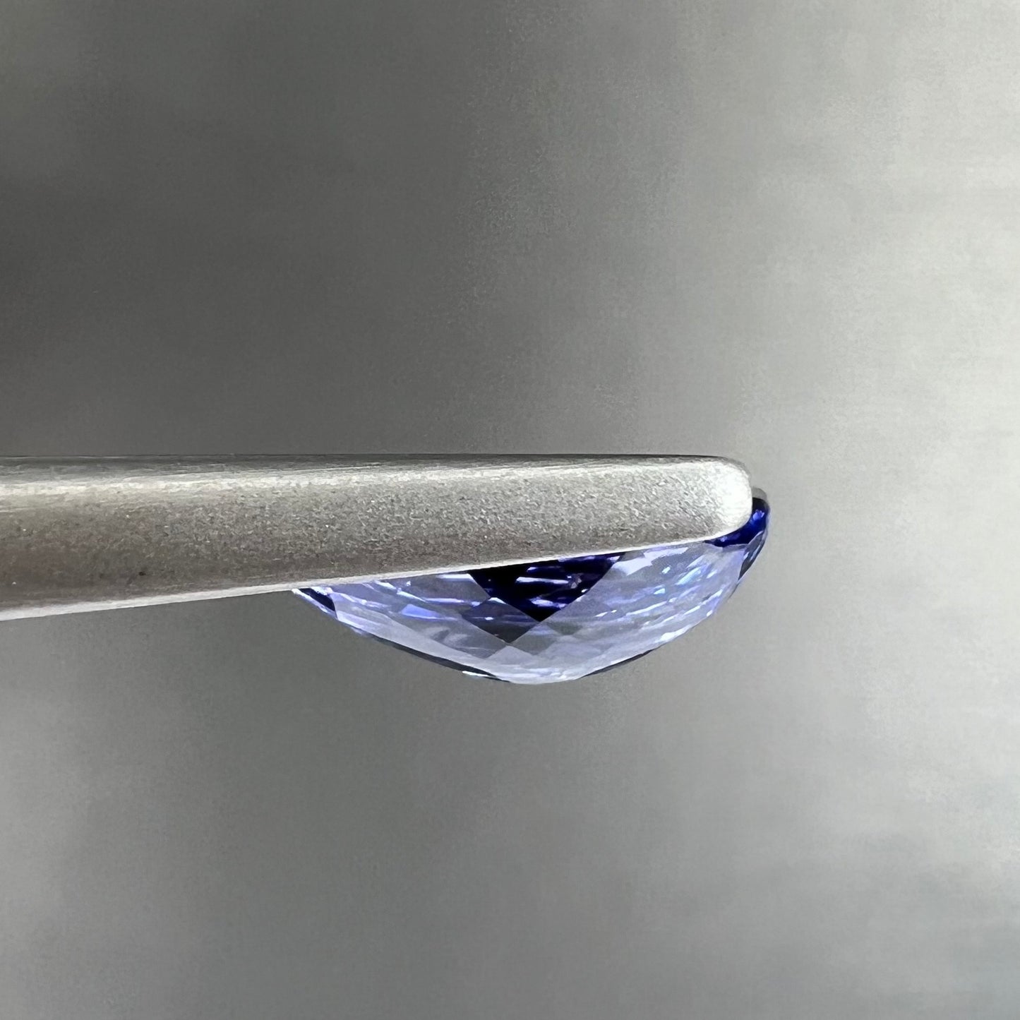 A loose, oval cut tanzanite gemstone.