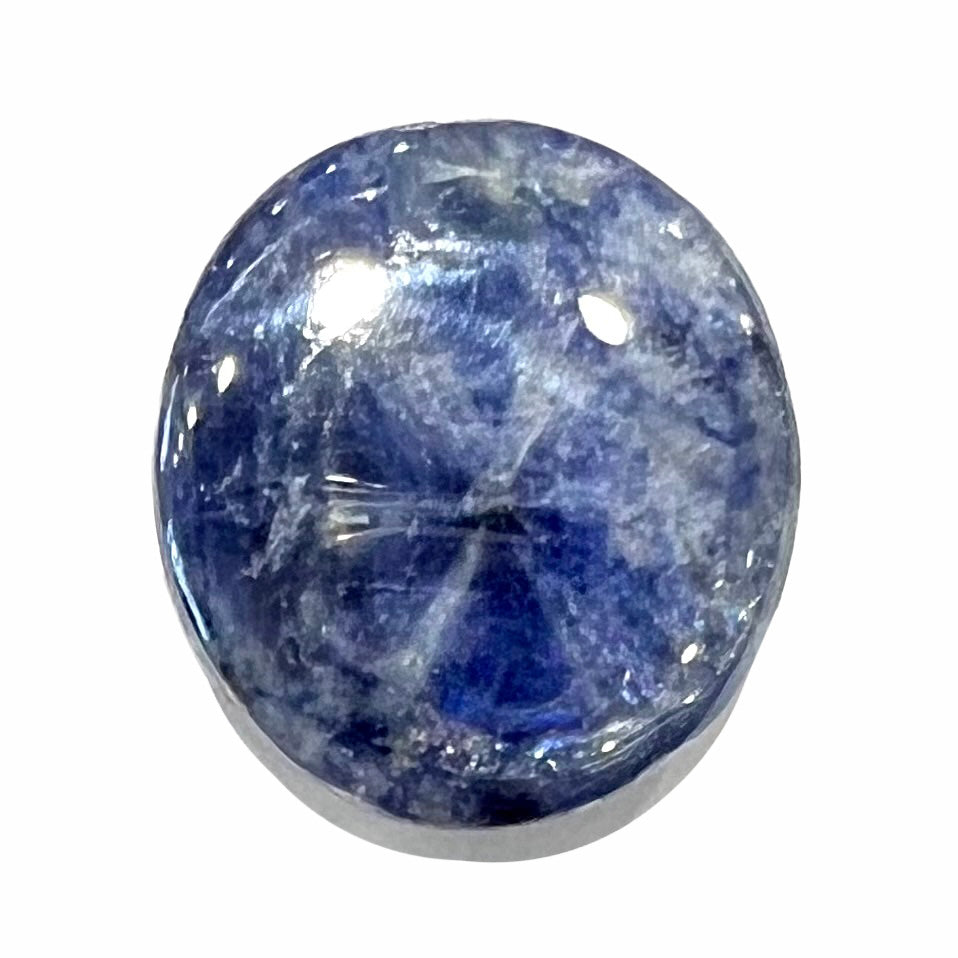 A loose, oval cabochon cut blue trapiche star sapphire stone.  The gem weighs 8.35 carats.