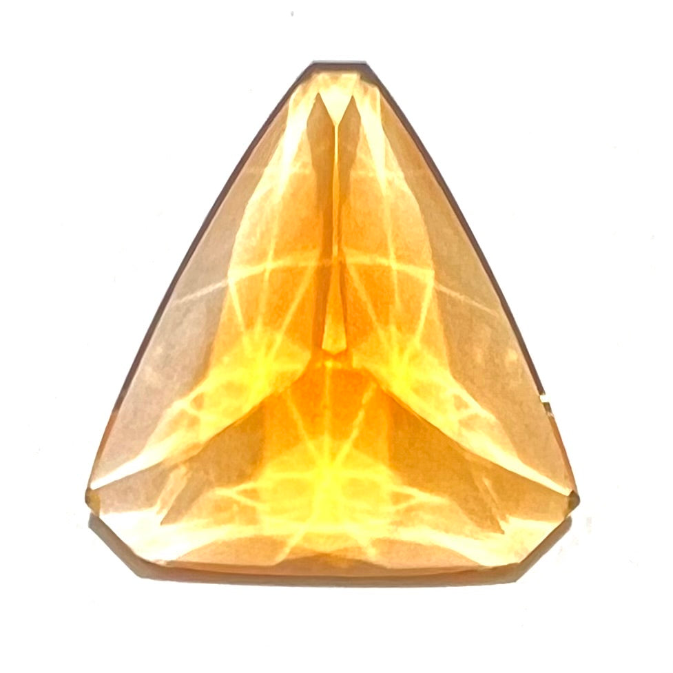 A loose, triangular fantasy cut yellow citrine stone cut by Arthur Lee Anderson.
