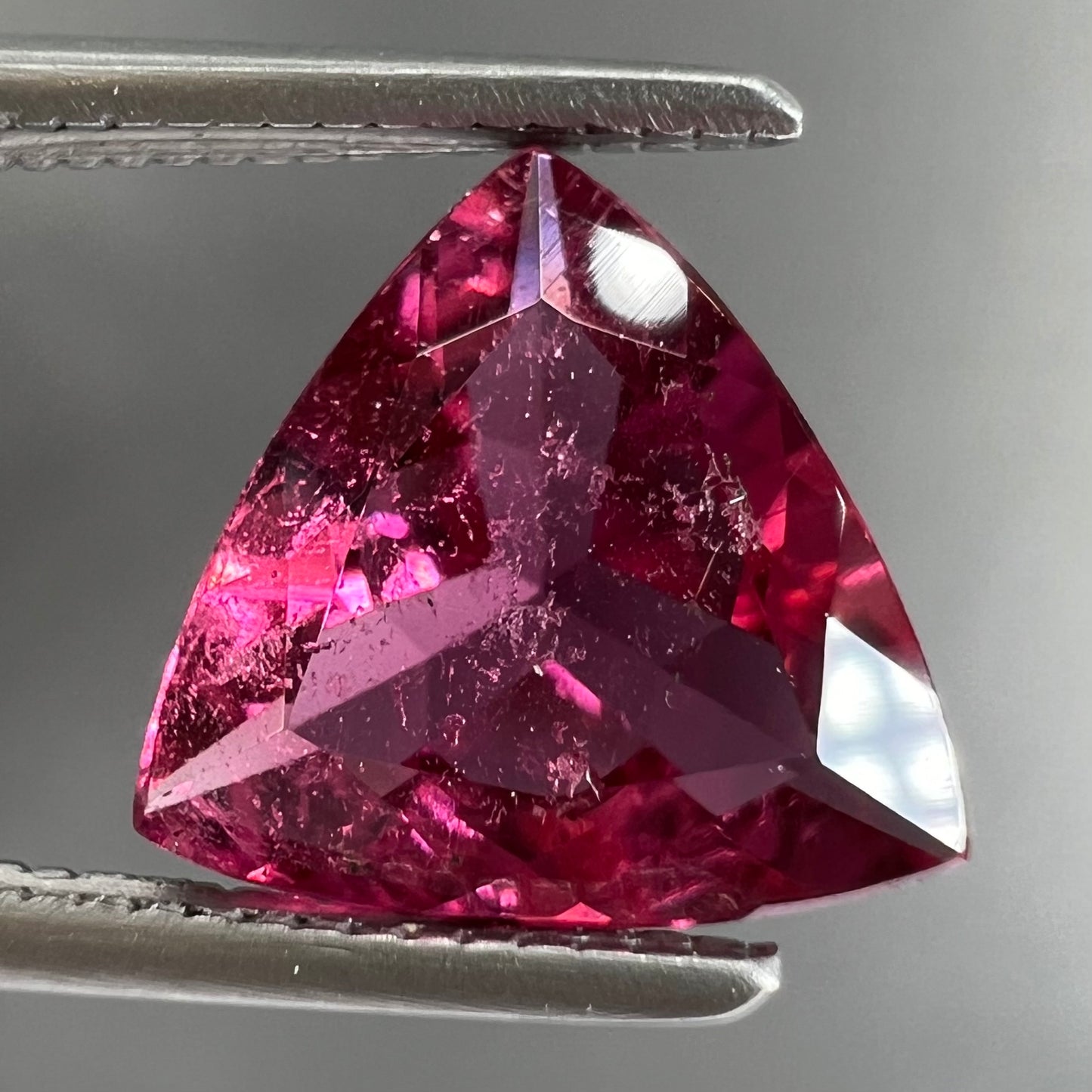 A trillion cut pink tourmaline gemstone.