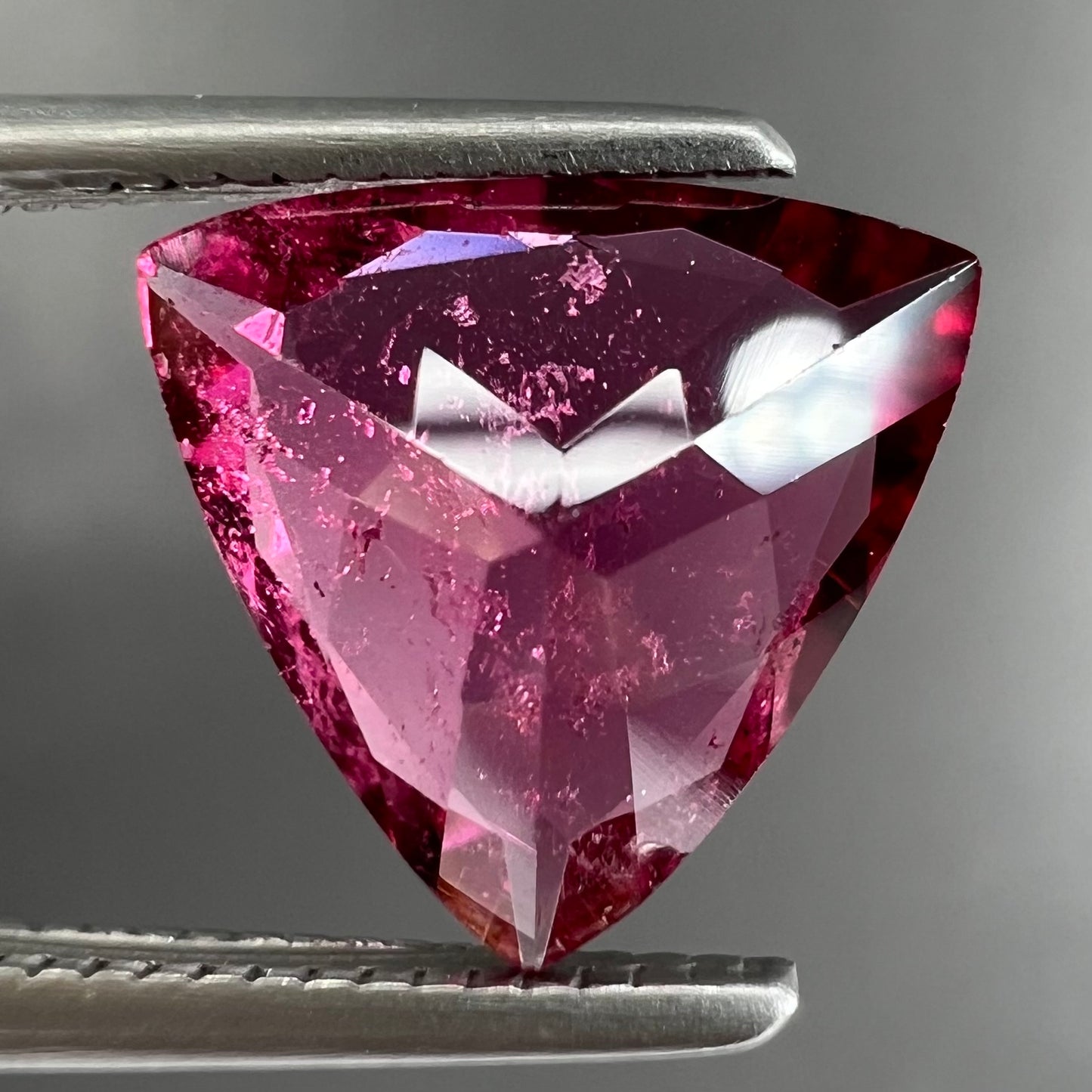 A trillion cut pink tourmaline gemstone.
