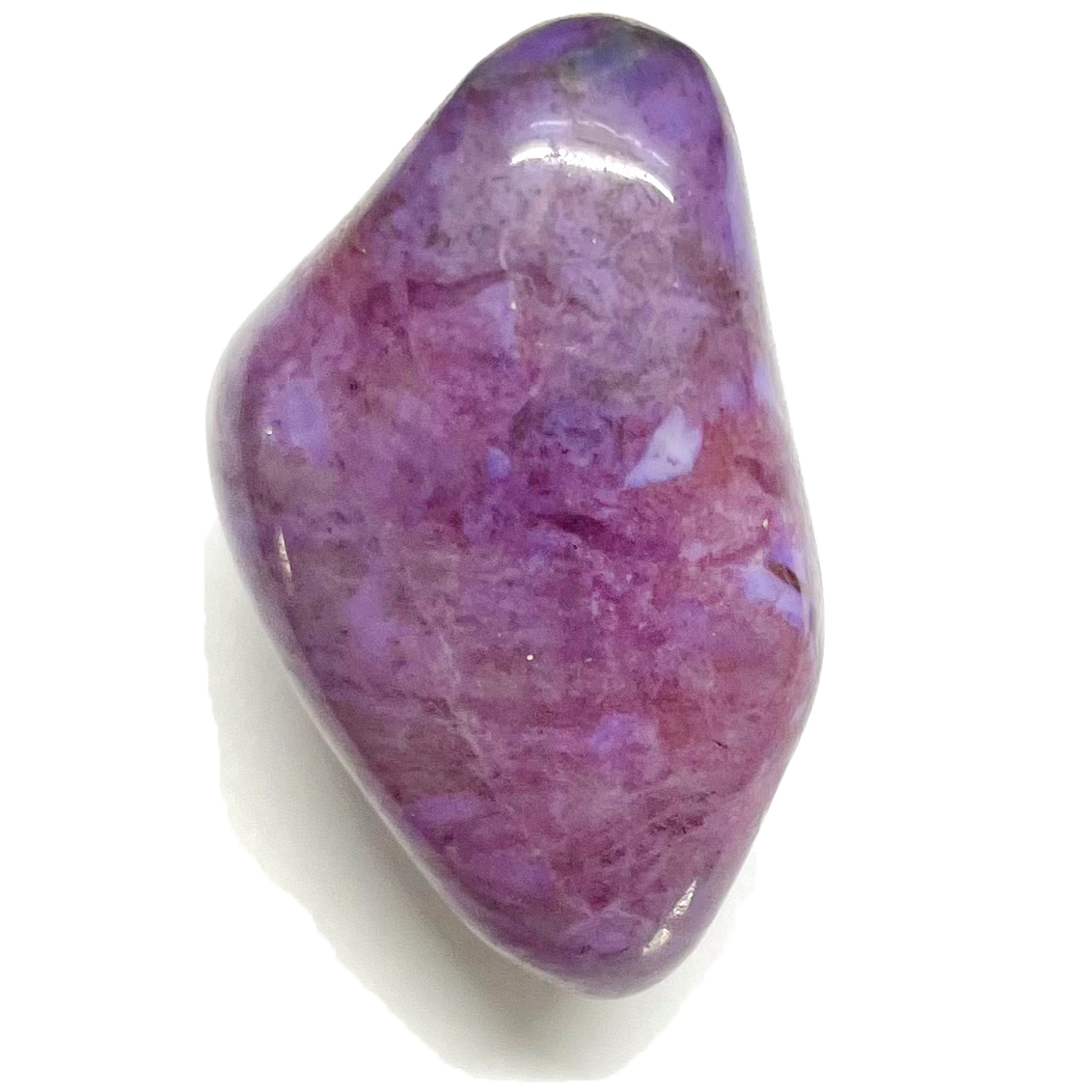 A tumble polished piece of purple turkieyenite jade.  The stone is purple with red, black, and white marbling.