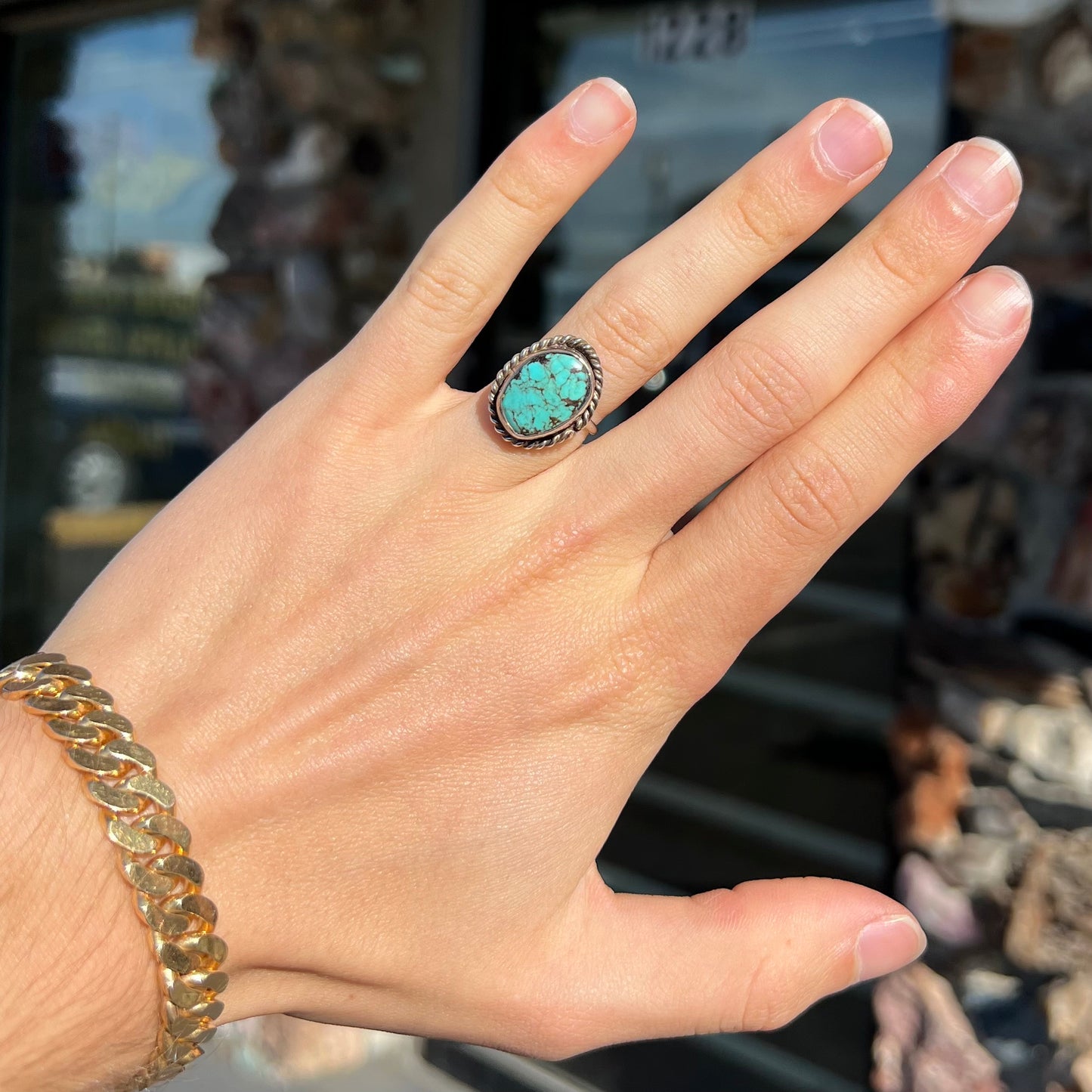 A handmade ladies' turquoise solitaire ring. The ring has a rope bezel design.