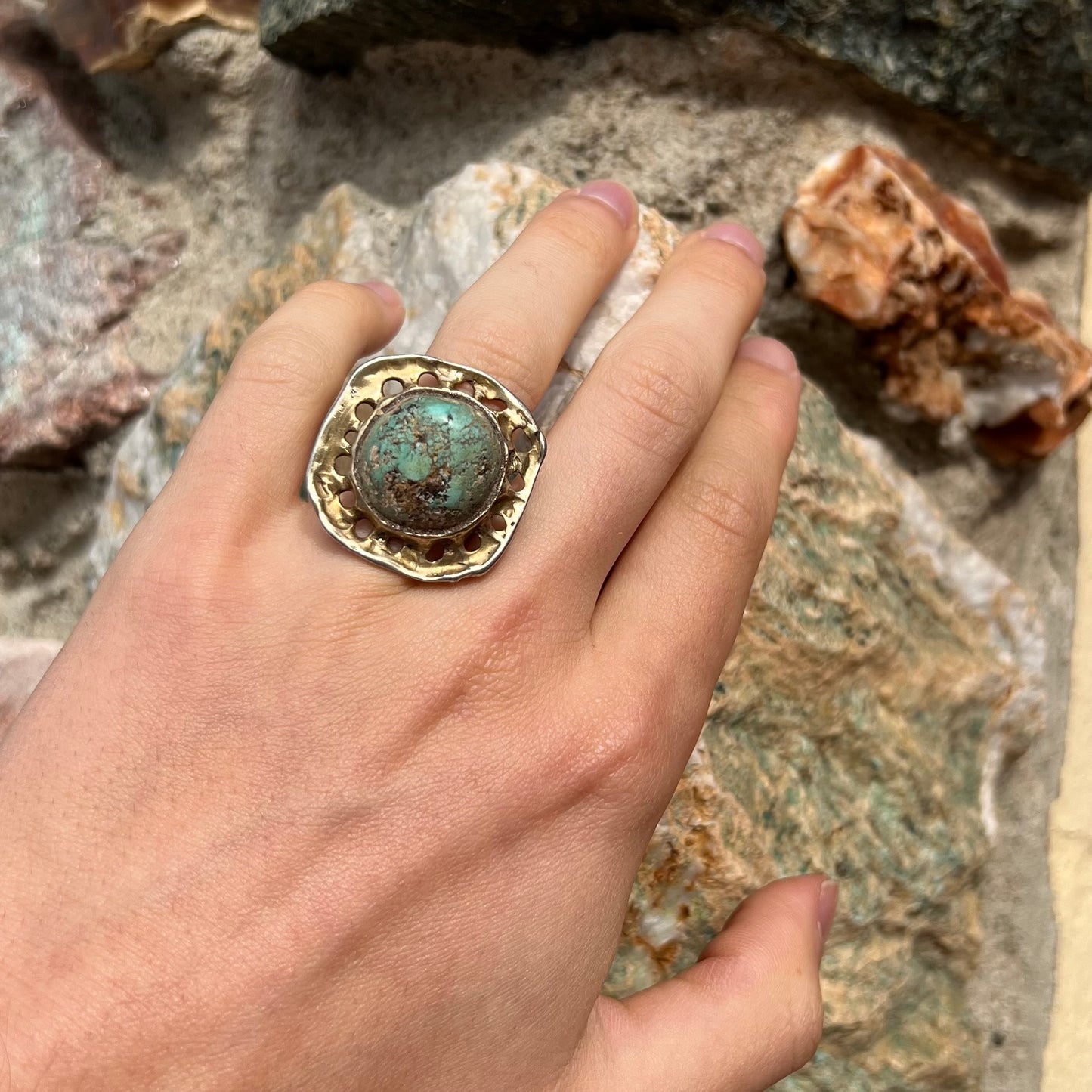 A unisex sterling silver ring with a gold wash, set with a natural, unstabilized Valley Blue turquoise stone.