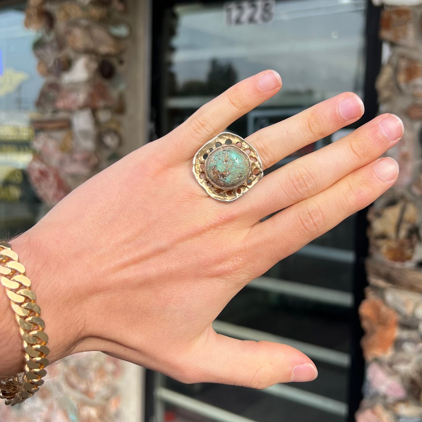 A unisex sterling silver ring with a gold wash, set with a natural, unstabilized Valley Blue turquoise stone.