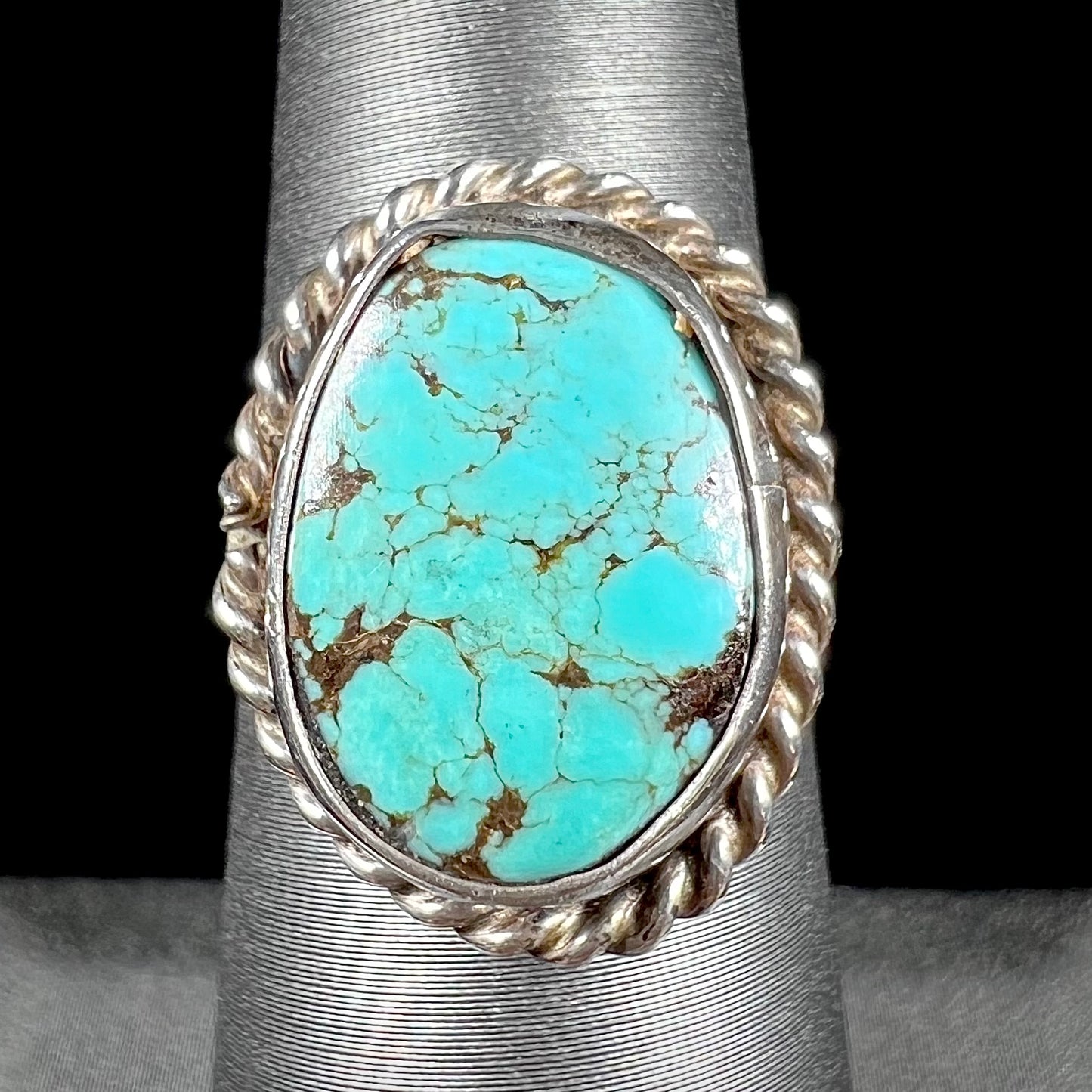 A handmade ladies' turquoise solitaire ring. The ring has a rope bezel design.