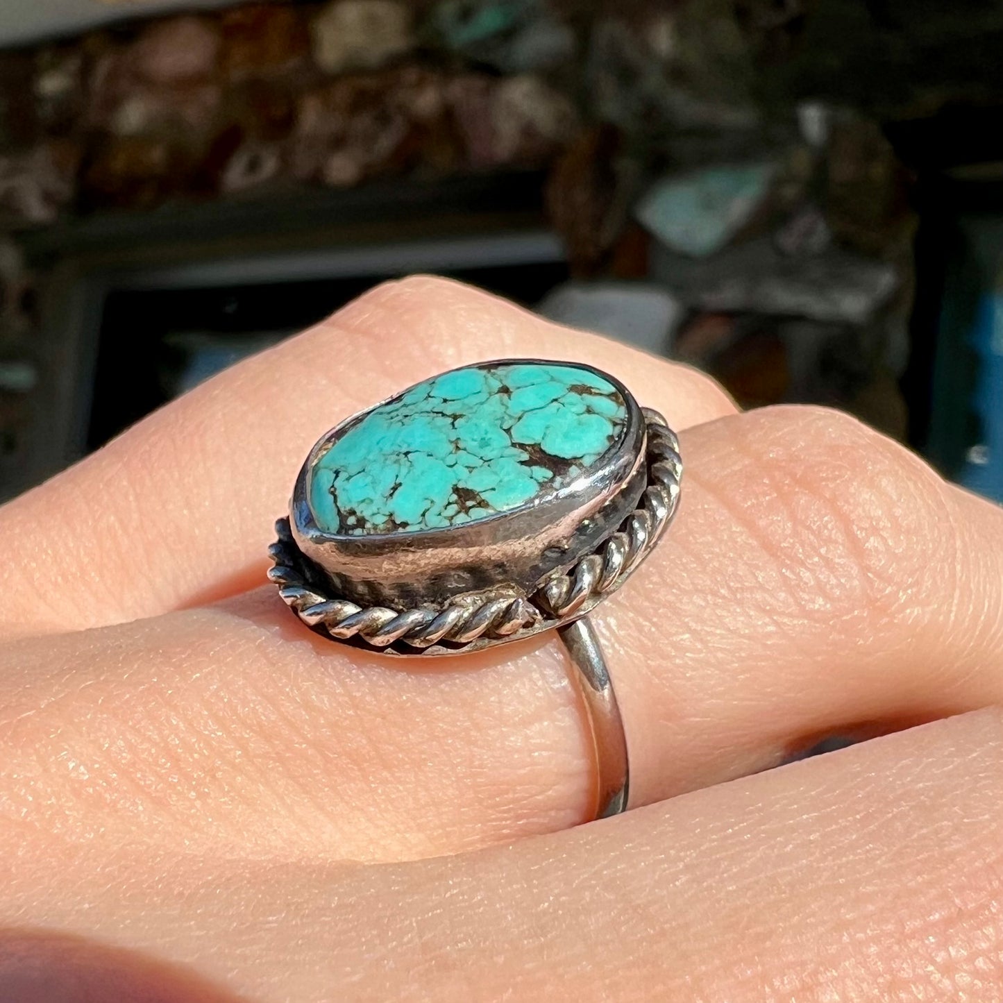 A handmade ladies' turquoise solitaire ring. The ring has a rope bezel design.