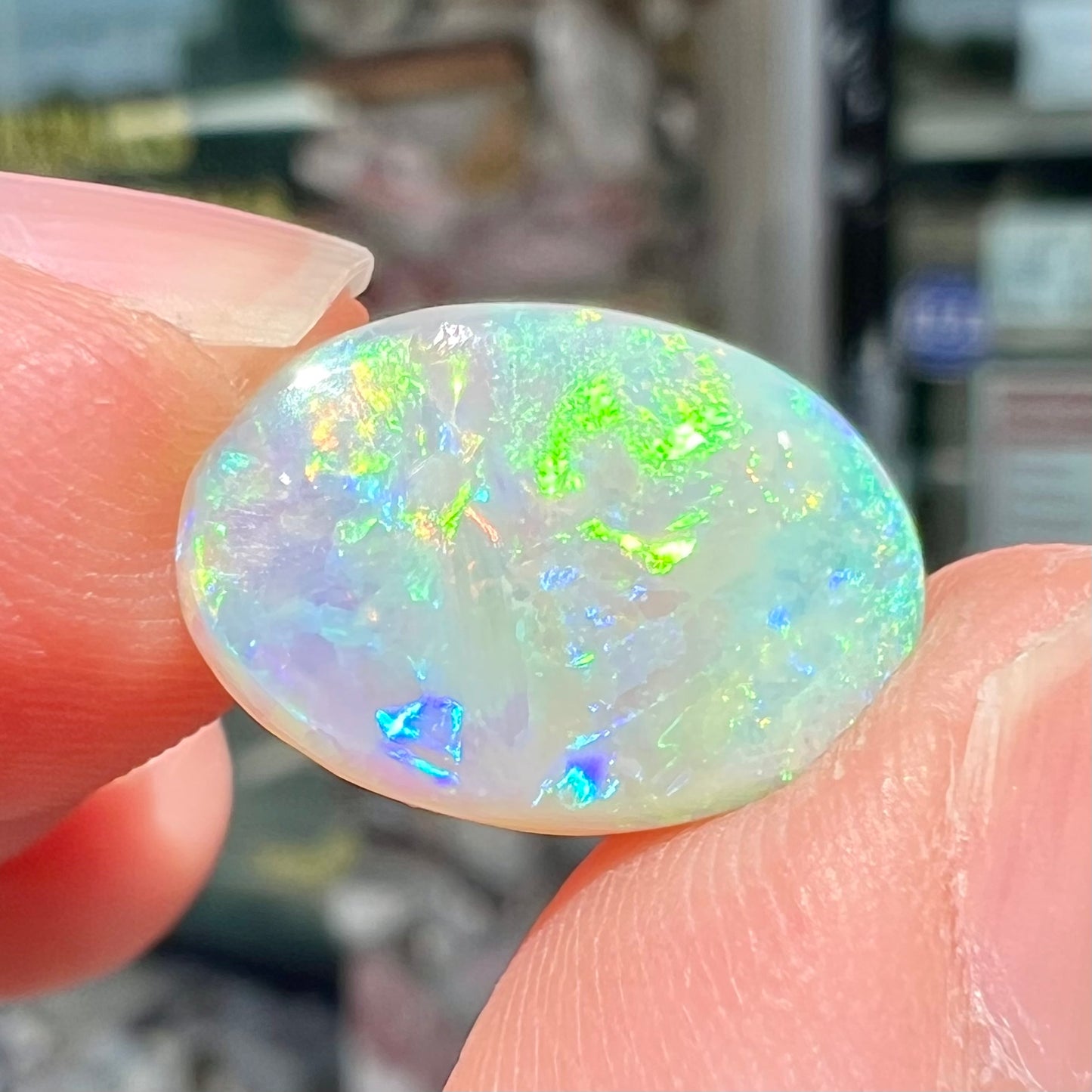 A double-sided opal stone from Coober Pedy, Australia. The opal plays green, blue, and orange colors from the front and the back.