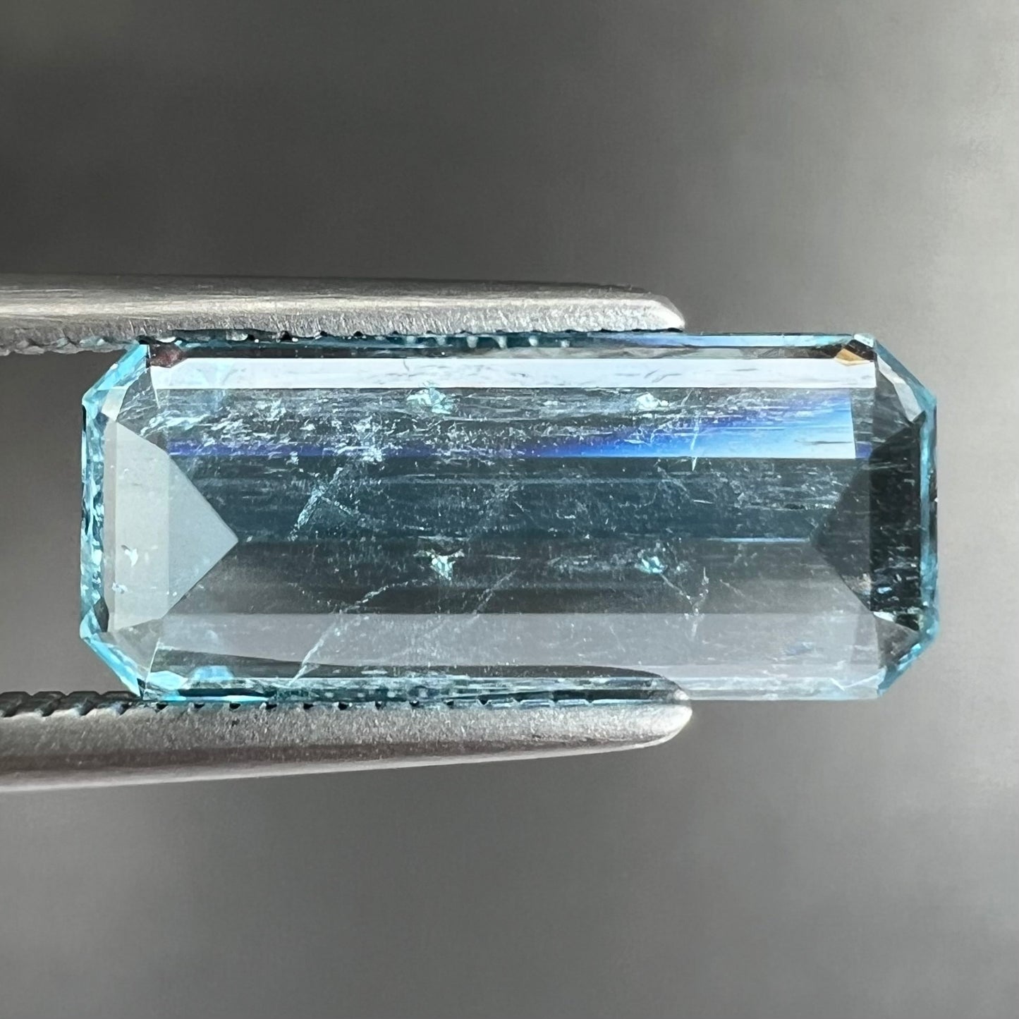 A loose, emerald cut aquamarine stone from Vietnam. The stone is an ice blue color.