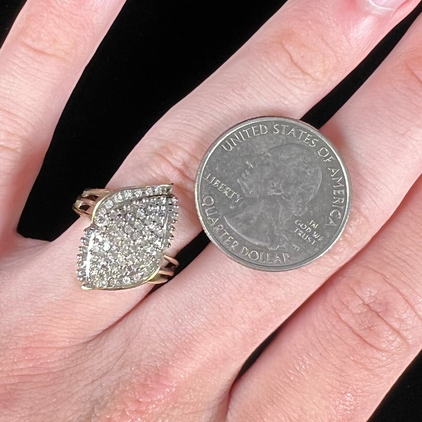 A ladies' yellow gold and diamond cluster ring. The diamonds are round and baguette shaped, and the ring is navette shaped.