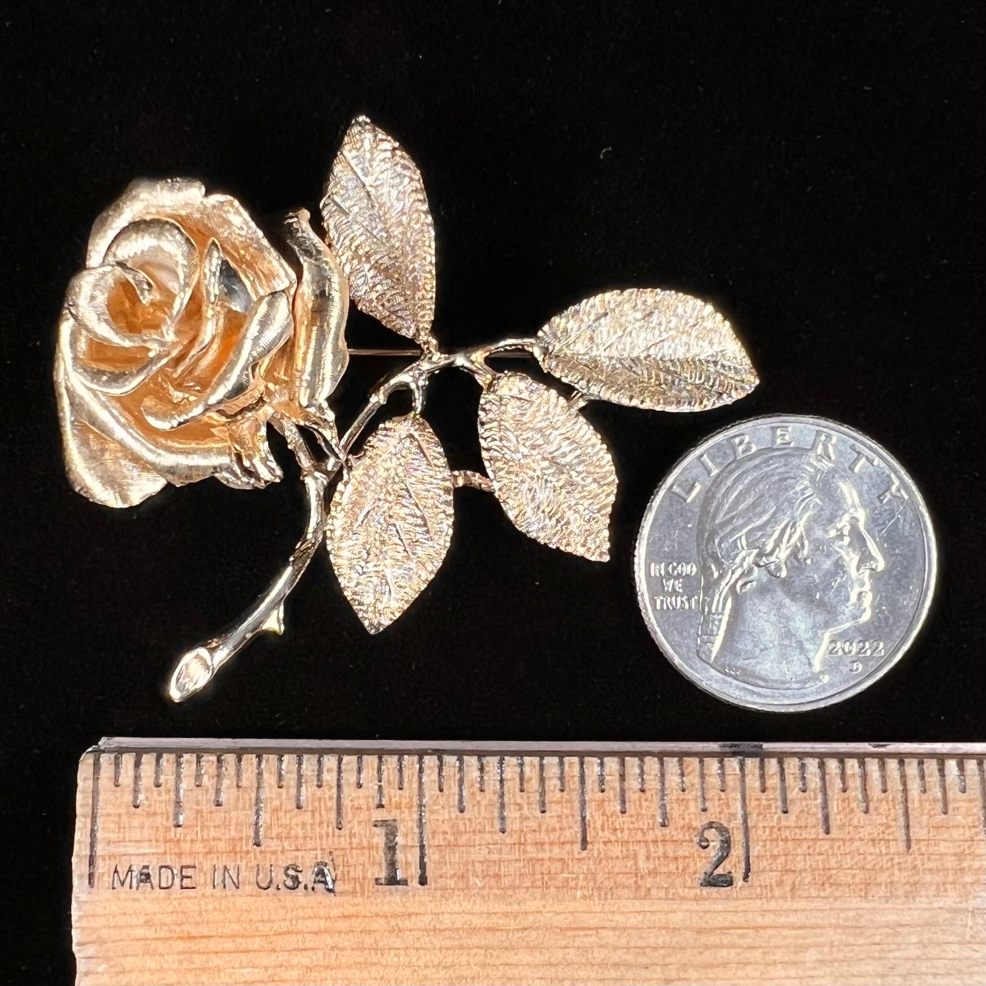 A vintage 14 karat yellow gold rose brooch.